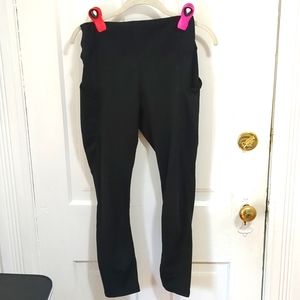 Black athletic leggings with pockets on both legs